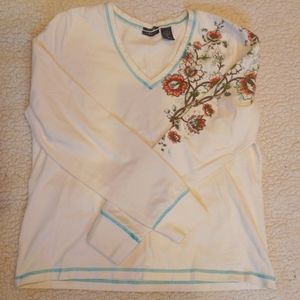 Izod long sleeve size large cream with floral design on arm/shoulder